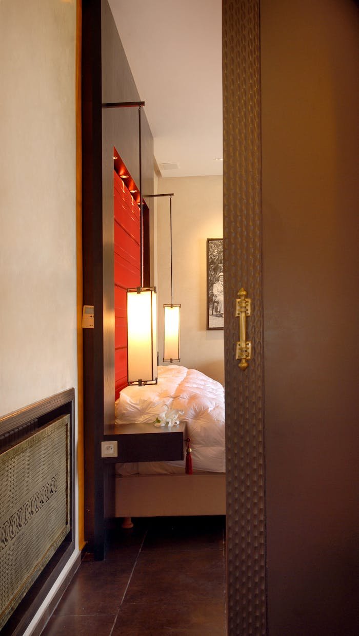 Luxurious bedroom entrance featuring elegant doors and contemporary lighting in a Marrakech hotel.